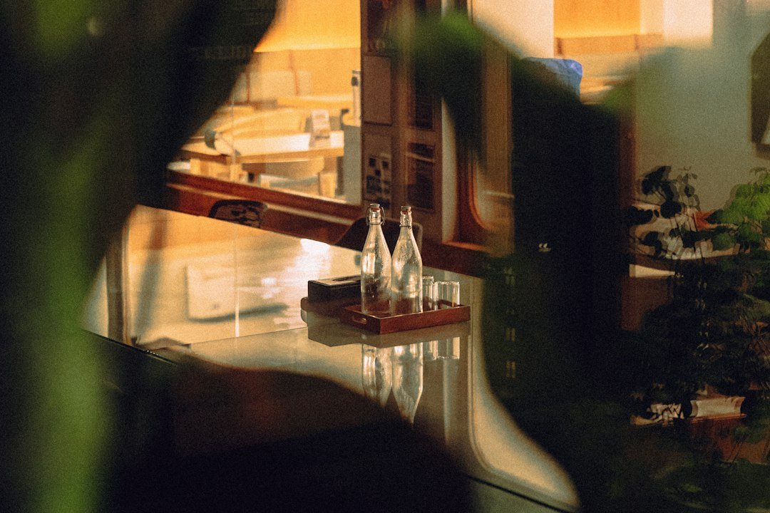 Beverage bottles and glasses arranged on a restaurant service tray
