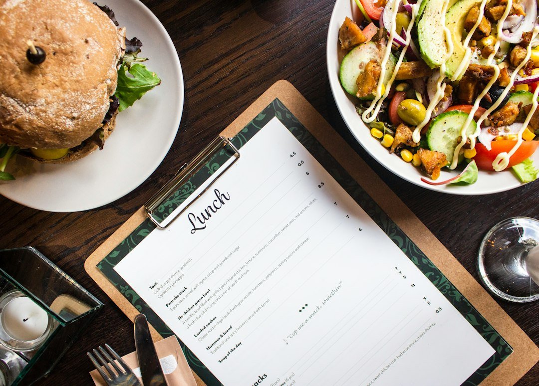 Clipboard and food on a restaurant operations table used for shift notes and manager handover