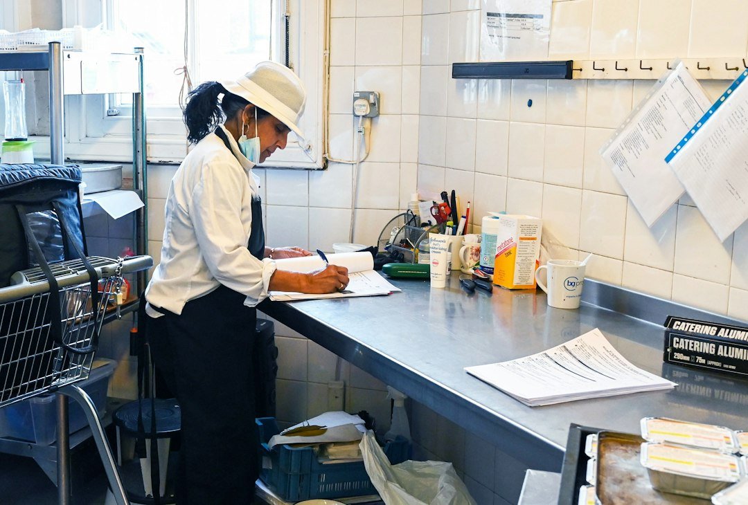 Restaurant worker reviewing an order list in a commercial kitchen