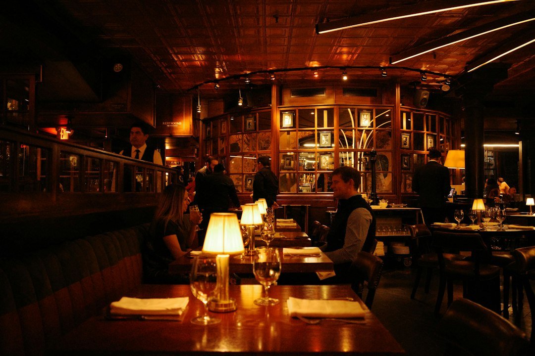 Busy restaurant dining room with guests seated at tables during evening service